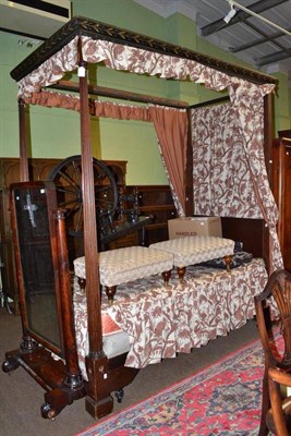 Lot 814 - A Regency mahogany four poster bed with fluted columns, the gallery painted with a continuous...