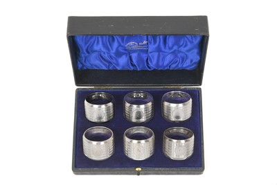 Lot 2106 - A Cased Set of Six George V Silver Napkin-Rings