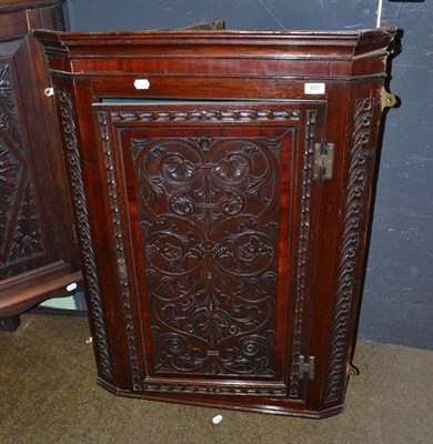 Lot 820 - Carved oak corner cupboard