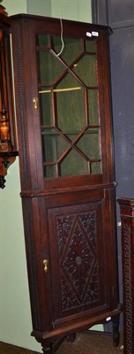 Lot 821 - An oak floor standing corner cupboard