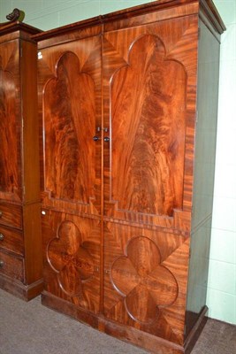 Lot 827 - A mahogany wardrobe with lobed panel doors