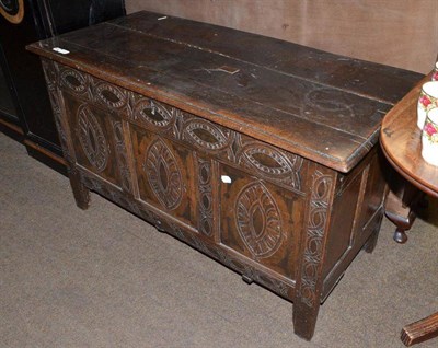 Lot 839 - A 17th century oak coffer with carved panels