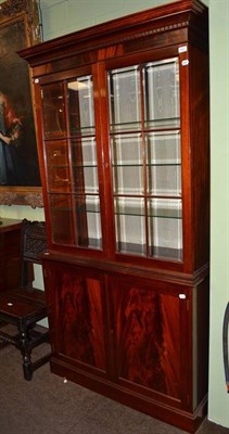 Lot 843 - Reproduction mahogany cupboard with three glass and one wood shelf (crack on one pane)