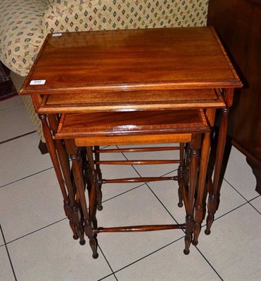 Lot 848 - A nest of three mahogany tables cross banded with satinwood