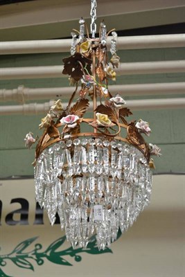 Lot 857 - A bronzed metal chandelier with cut crystal drops and decorated with porcelain roses