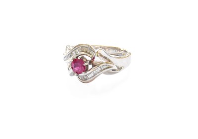 Lot 321 - A Ruby and Diamond Ring, the raised round cut...