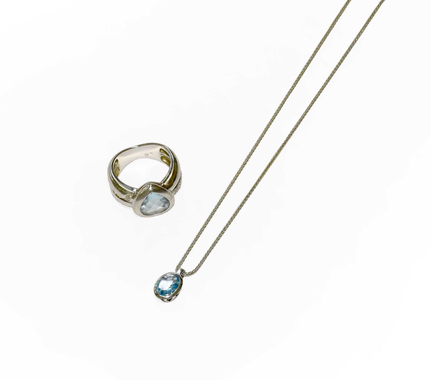 Lot 19 - A 9 Carat White Gold Blue Topaz Pendant on...