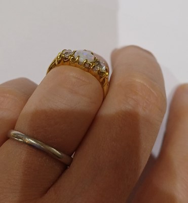 Lot 23 - An Opal and Diamond Three Stone Ring, the...