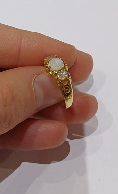 Lot 23 - An Opal and Diamond Three Stone Ring, the...