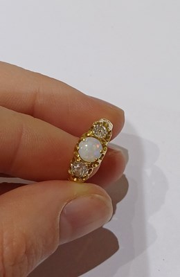 Lot 23 - An Opal and Diamond Three Stone Ring, the...