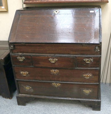 Lot 1384 - A George III Oak Bureau, on bracket supports,...