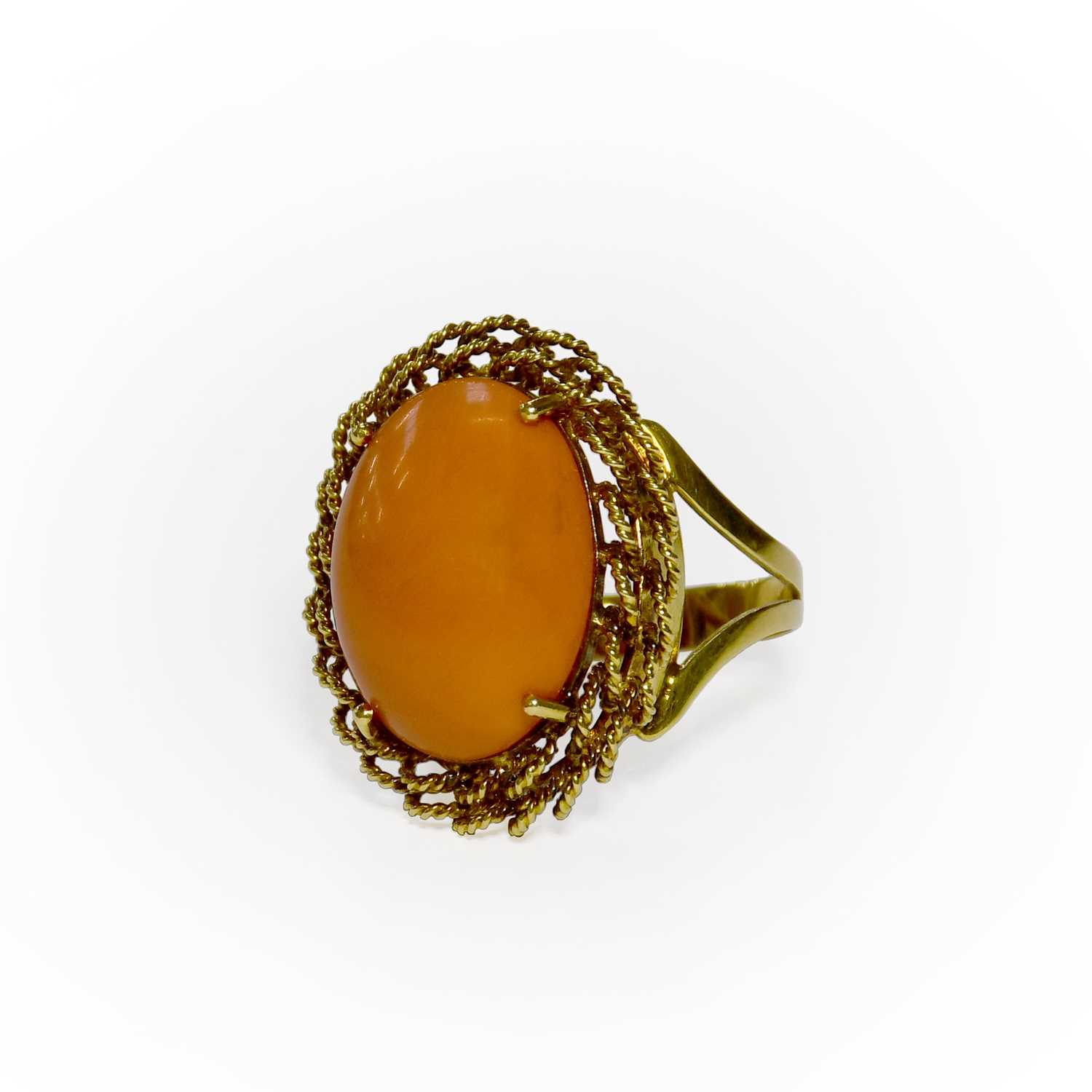 Lot 3 - A Coral Ring, the oval cabochon coral in a...