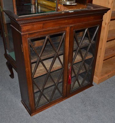 Lot 947 - A mahogany bookcase cabinet with astragal glazed doors