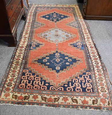 Lot 1091 - Gendje Long Rug, the madder field with three...