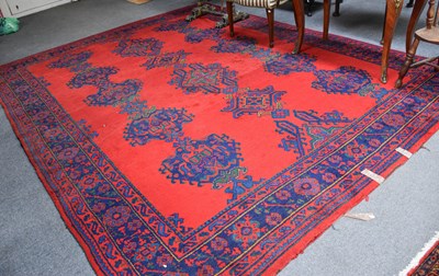 Lot 1197 - Ushak Carpet, the tomato red field with three...