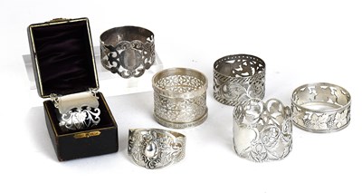 Lot 8 - Seven Assorted Silver Napkin-Rings, each...