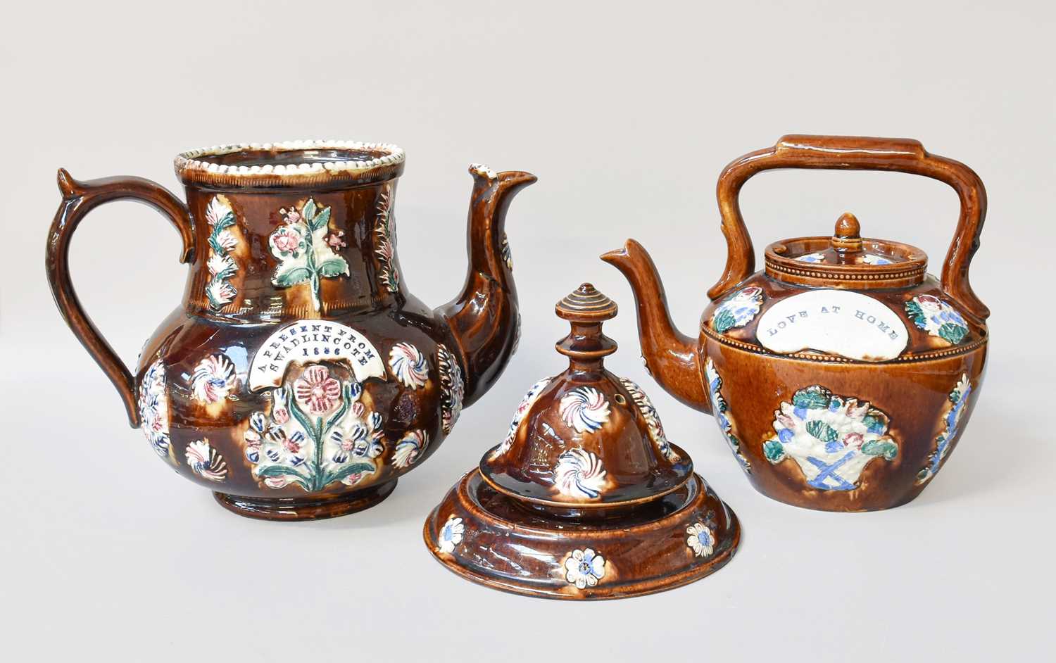 Lot 142 - A 19th Century Measham Bargeware Teapot, cover...