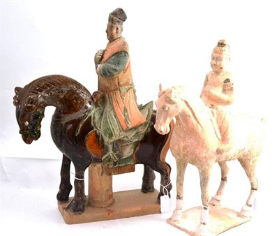 Lot 28 - A Tang polychrome decorated earthenware horse and rider and another Tang style figure on horseback