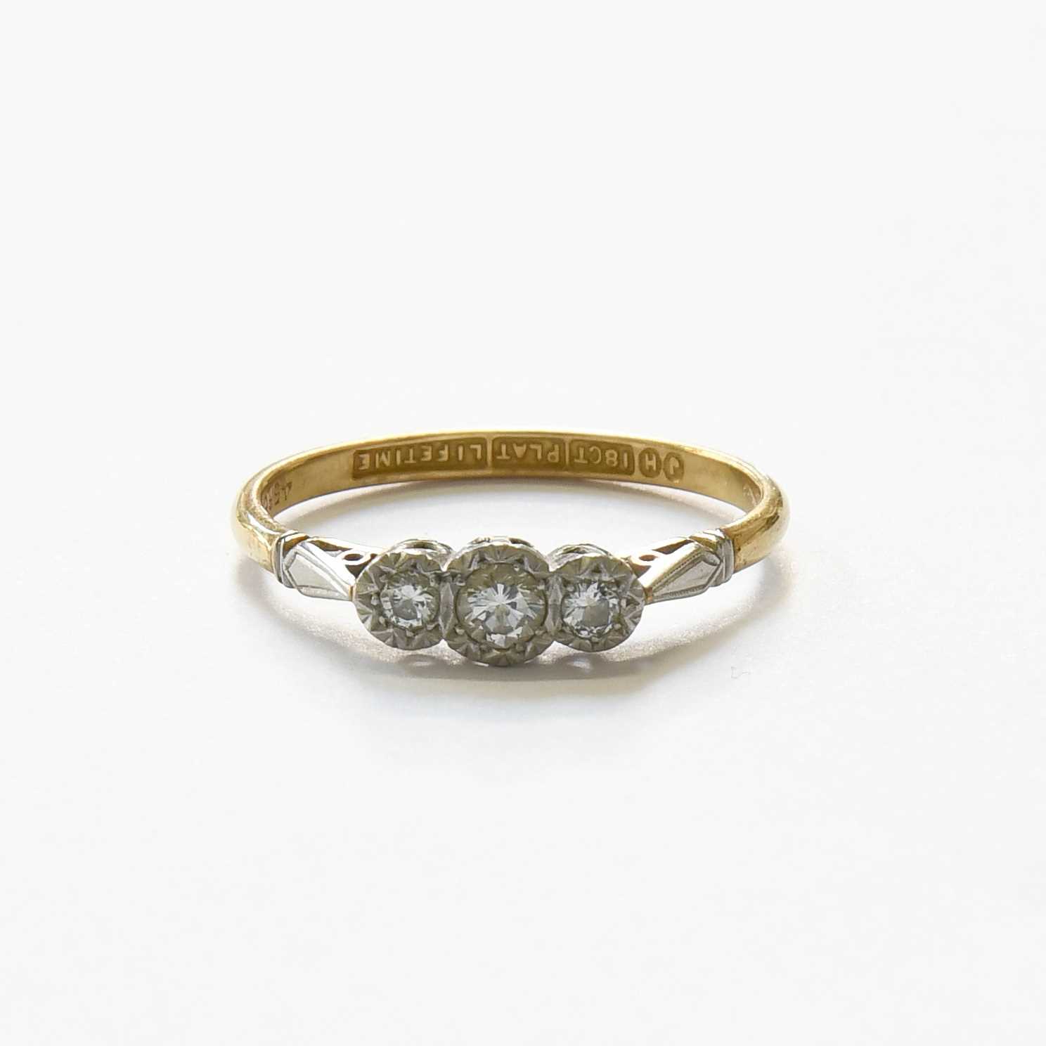 Lot 63 - A Diamond Three Stone Ring, the graduated...