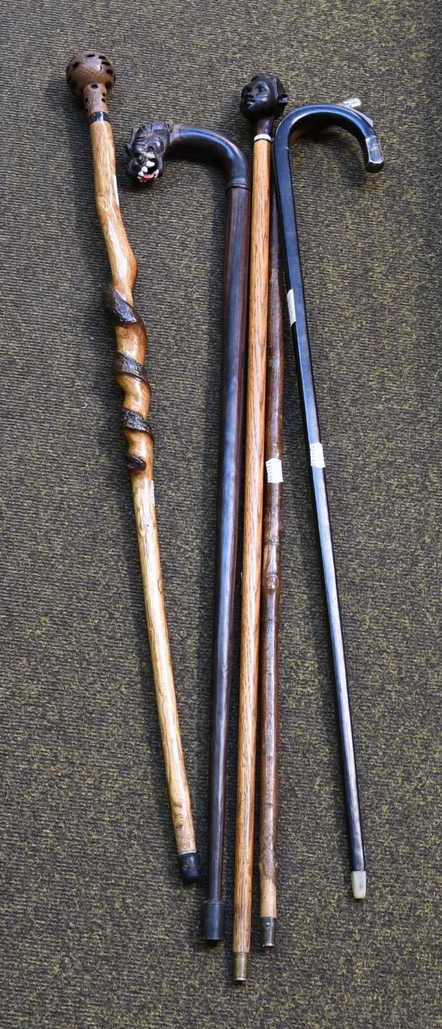 Lot 129 - A Burmese Macassar Ebony Walking Stick, an...