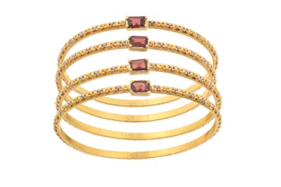 Lot 2206 - Four 22 Carat Gold Garnet Bangles each...