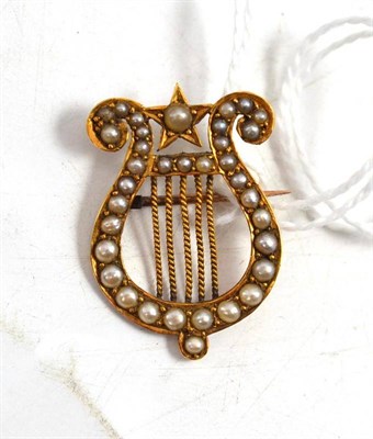 Lot 99 - A seed pearl set lyre brooch, stamped '18C'