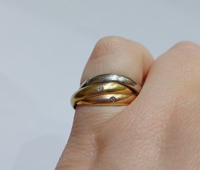 Lot 2250 - A Diamond Trinity Ring, by Cartier comprising...
