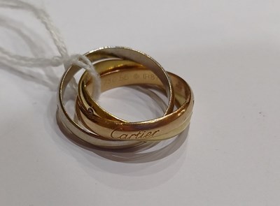 Lot 2250 - A Diamond Trinity Ring, by Cartier comprising...