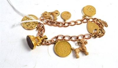 Lot 111 - A charm bracelet hung with eight charms