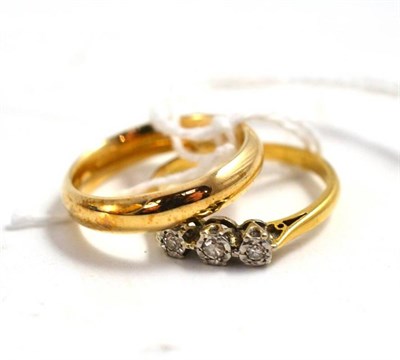Lot 133 - A 9ct gold band ring and three stone diamond ring