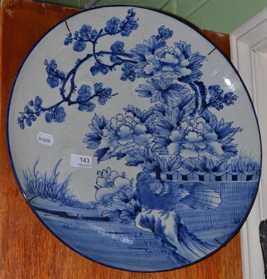 Lot 143 - A large blue and white Chinese charger painted with flowers and a pigeon