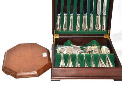 Lot 183 - A Mouseman breadboard and a canteen of Elkington silver plated cutlery (eight settings) (2)