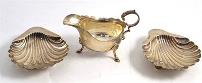 Lot 200 - Two silver shell butter dishes and a silver sauceboat