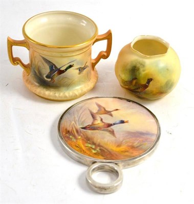 Lot 202 - A Stinton hand mirror (a.f.), a two handled mug and a small vase with pheasants (3)