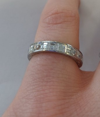 Lot 2300 - A Diamond Eternity Ring twenty square cut...