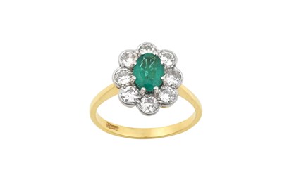 Lot 2239 - An Emerald and Diamond Cluster Ring the oval...