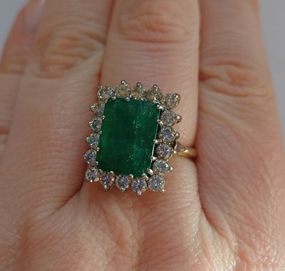 Lot 2233 - An Emerald and Diamond Cluster Ring the...