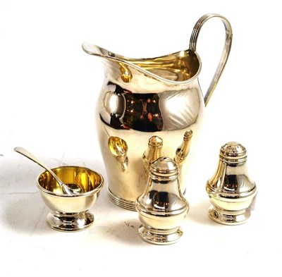 Lot 219 - A silver baluster cream jug, Birmingham 1915 and a three piece condiment set with spoon