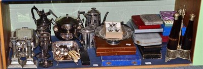 Lot 241 - A shelf of plated ware including three bottle decanter stand, cased flatware, two pairs of...