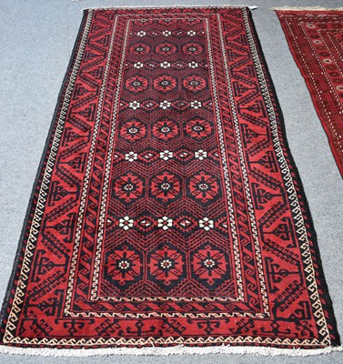 Lot 1218 - Baluch Rug, the charcoal field of stylised...