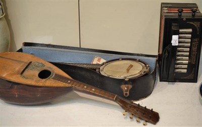 Lot 243 - A mandolin, banjo and melodian