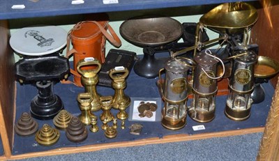 Lot 254 - Three miner's lamps, scales, weights, etc