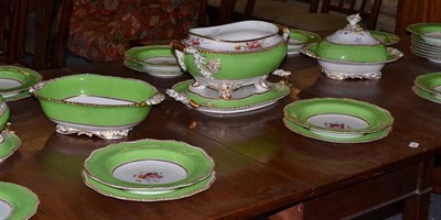 Lot 257 - A 19th century porcelain dinner service with painted floral sprays and green border