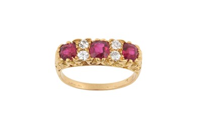 Lot 2070 - A Ruby and Diamond Seven Stone Ring three...