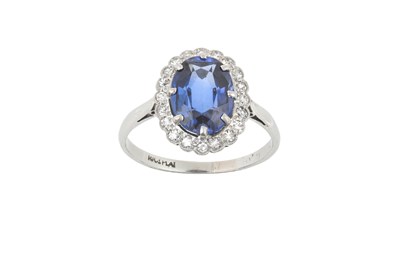 Lot 2092 - A Sapphire and Diamond Cluster Ring the oval...