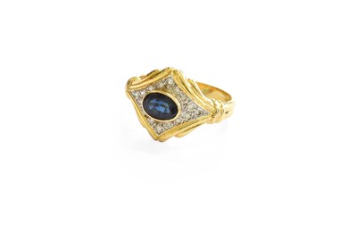 Lot 449 - A Sapphire and Diamond Ring, the oval cut...