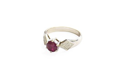 Lot 398 - A Red Stone and Diamond Ring, the round cut...