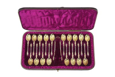 Lot A Cased Set of Eighteen Victorian Silver-Gilt Teaspoons and a Pair of Sugar-Tongs En Suite