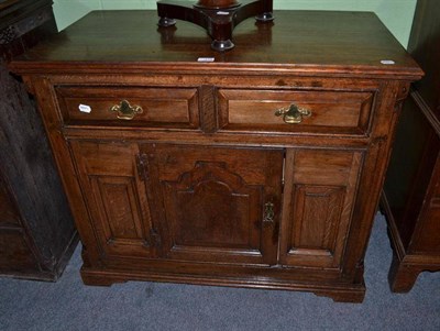 Lot 419 - 19th century panelled oak sideboard with two drawers above a cupboard door