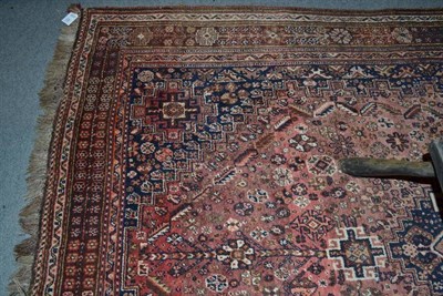 Lot 457 - Kashgai carpet, South West Persia, the faded raspberry field centred by an indigo stepped medallion